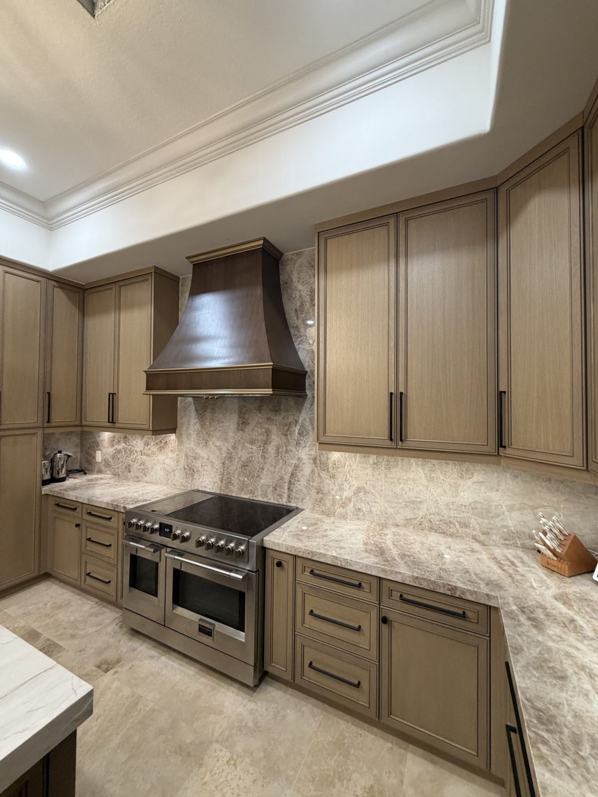 Boca Raton kitchen with custom wood cabinetry and range hood